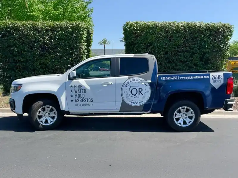 Pickup truck with Quick Restore Arizona logo and services listed including fire, water, mold, and asbestos restoration. trusted restoration company in Tucson
